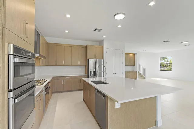 a kitchen with a sink and a stove top oven