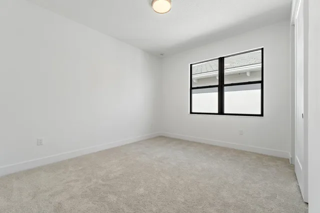 an empty room with windows and closet