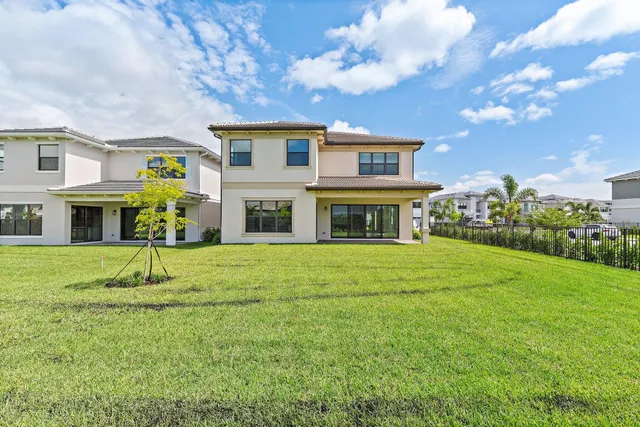 a view of a balcony with two chairs and a potted plant