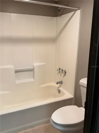 a bathroom with a toilet and a bathtub