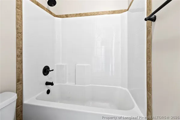 a bathroom with a tub and a shower