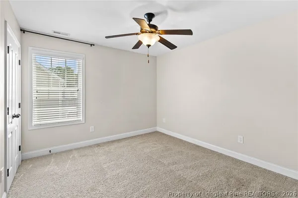 a view of room with window and ceiling fan