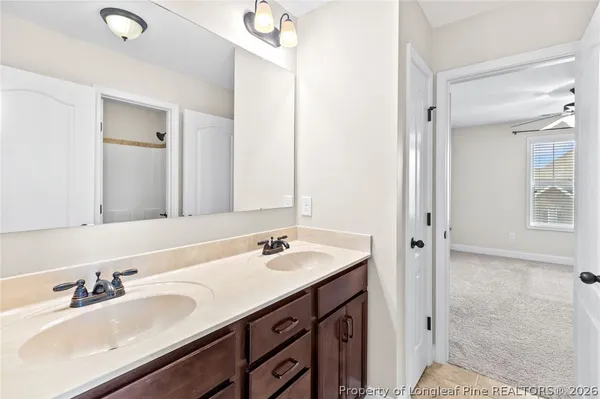 a bathroom with a sink double vanity and a mirror
