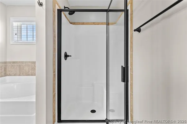 a bathroom with a glass shower door