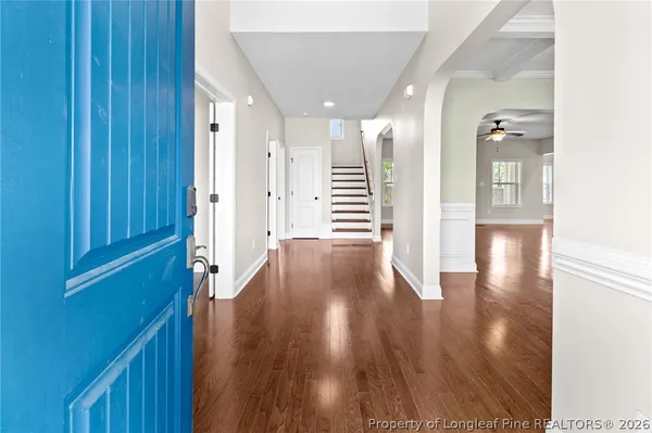 a view of a hallway with wooden floor