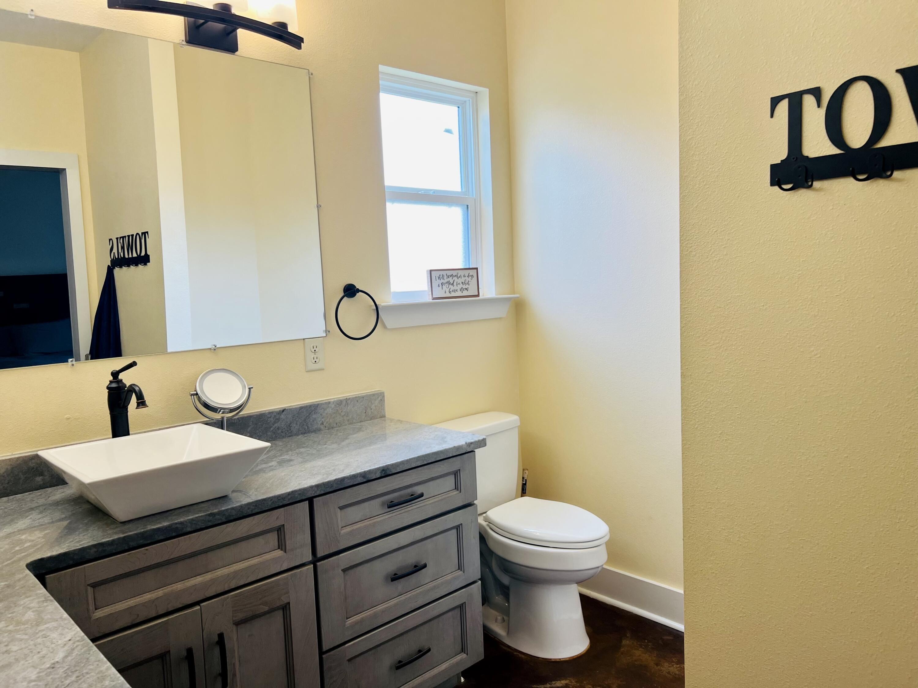 5170 Poplar Head Church Road Holt, FL 32564 - Photo 19 of 35 a bathroom with a granite countertop sink toilet and mirror