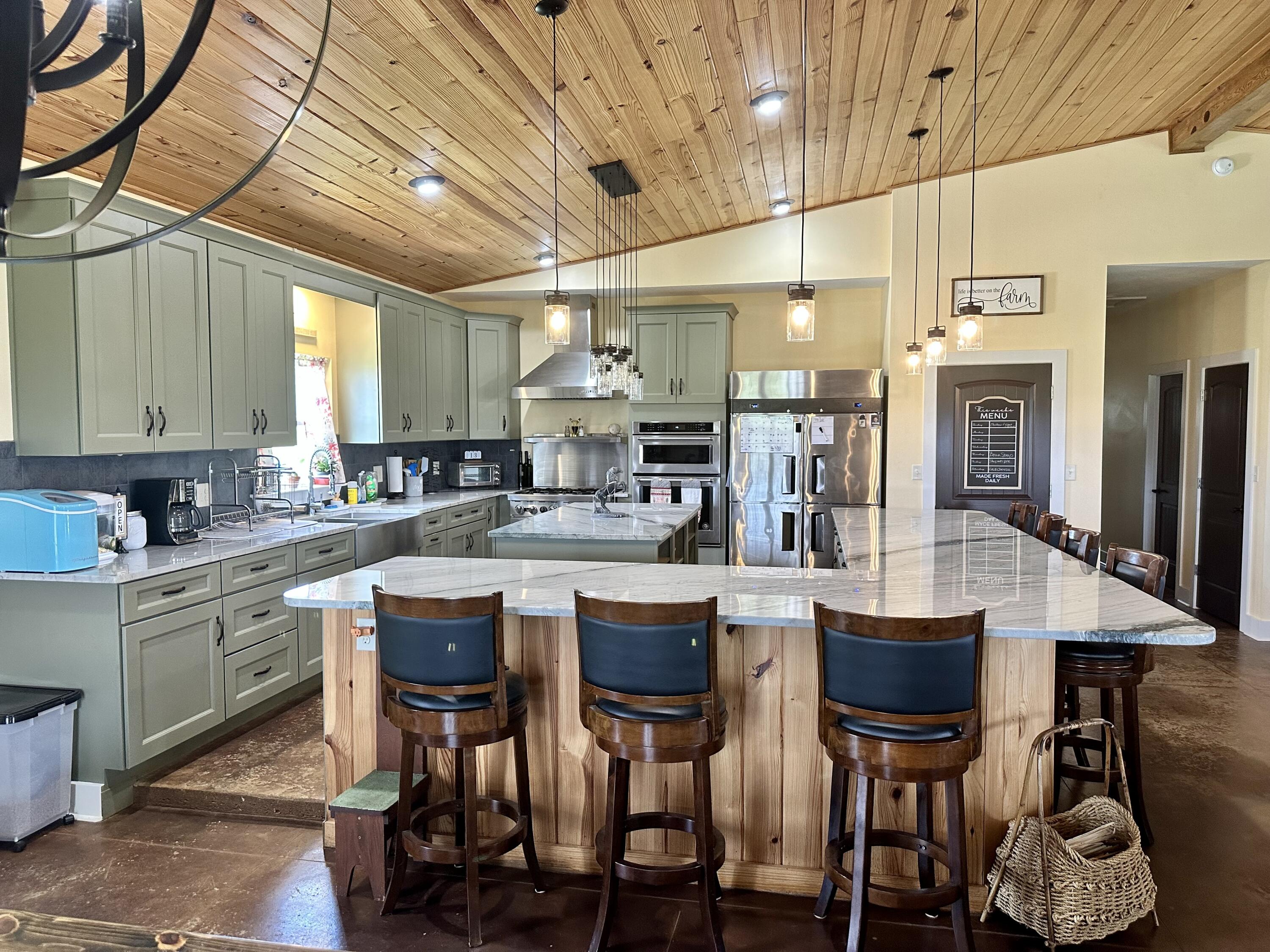 5170 Poplar Head Church Road Holt, FL 32564 - Photo 7 of 35 a kitchen with cabinets and chairs
