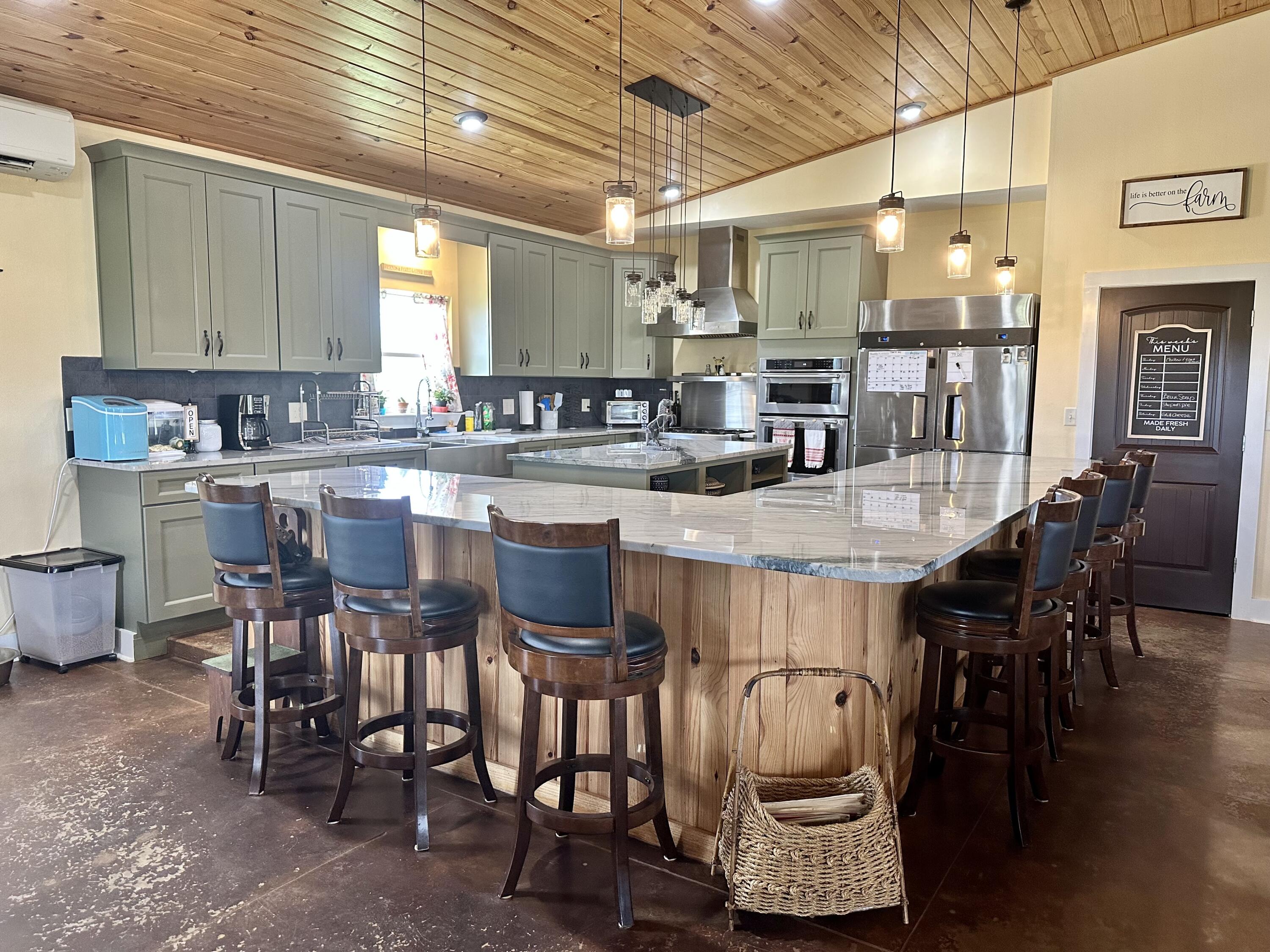 5170 Poplar Head Church Road Holt, FL 32564 - Photo 10 of 35 a large kitchen with a table and chairs