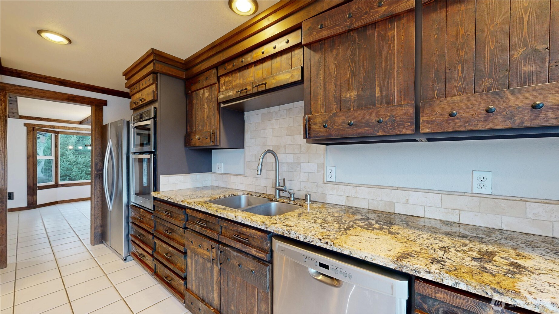 5810 Meridian Road Southeast Olympia, WA 98513 - Photo 22 of 40 a kitchen with granite countertop a sink and wooden cabinets