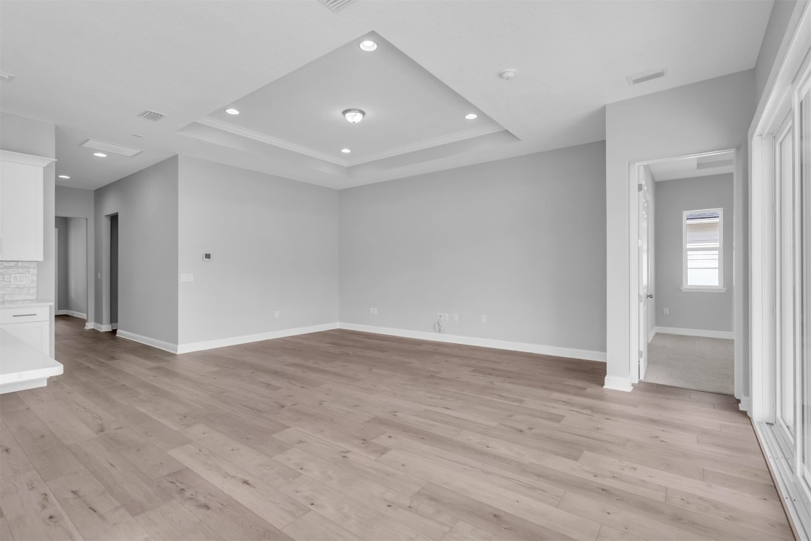 454 Slash Pine Place Yulee, FL 32097 - Photo 11 of 34 an empty room with wooden floor and windows