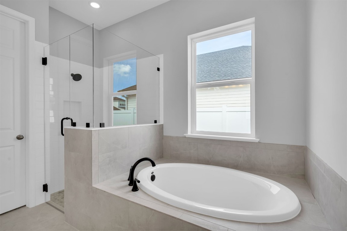 454 Slash Pine Place Yulee, FL 32097 - Photo 20 of 34 a bathroom with a bathtub