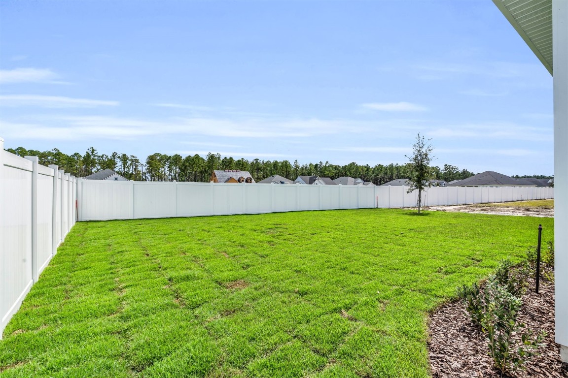 454 Slash Pine Place Yulee, FL 32097 - Photo 23 of 34 a view of outdoor space with a building in the background