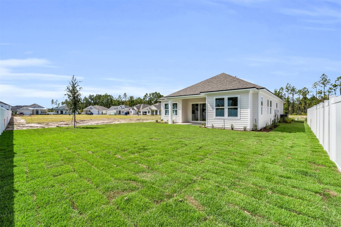 454 Slash Pine Place Yulee, FL 32097 - Photo 24 of 34 a front view of a house with a yard