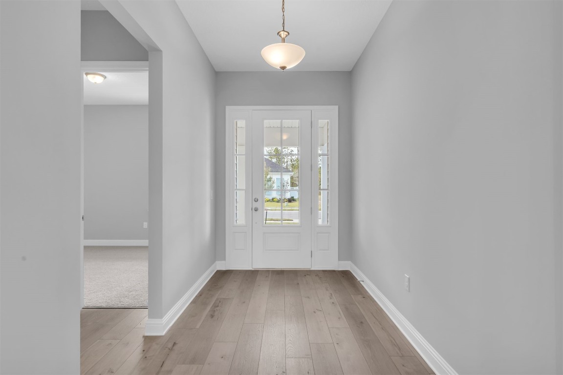 454 Slash Pine Place Yulee, FL 32097 - Photo 5 of 34 a view of an empty room with window and wooden floor