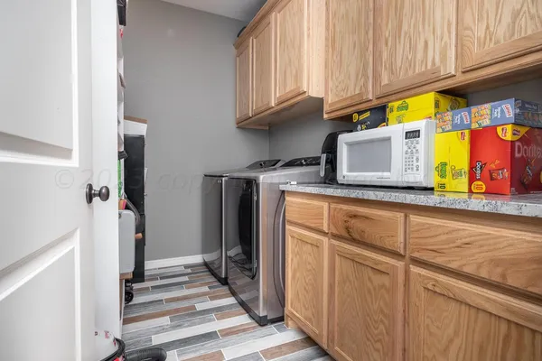 a kitchen with stainless steel appliances granite countertop a refrigerator and microwave