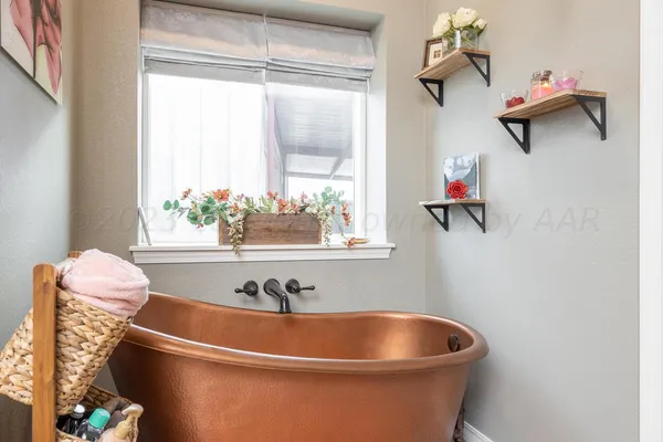 a white bath tub sitting next to a window