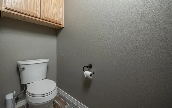 a white toilet sitting next to a window