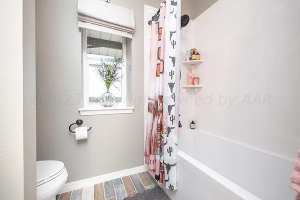 a bathroom with a bathtub a toilet and a shower