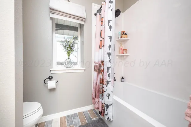 a bathroom with a bathtub a toilet and a shower