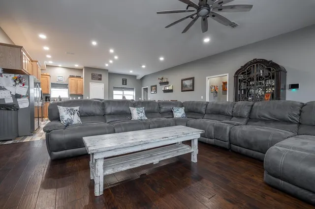 a living room with furniture and a ceiling fan