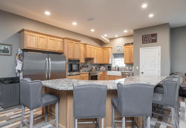 a kitchen with granite countertop a counter space stainless steel appliances and cabinets