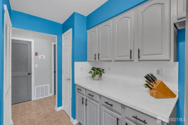 a kitchen with a sink a stove and cabinets