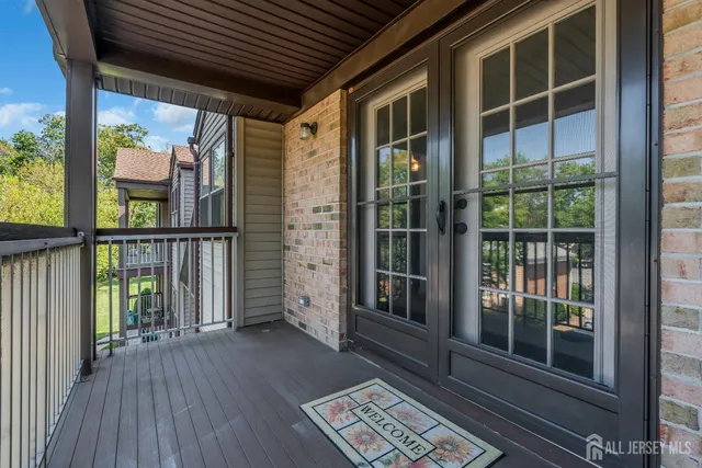 a view of front door and porch with wooden floor