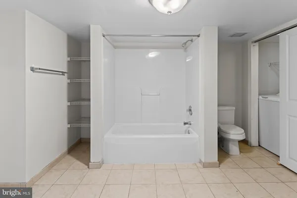 a bathroom with a toilet and a shower