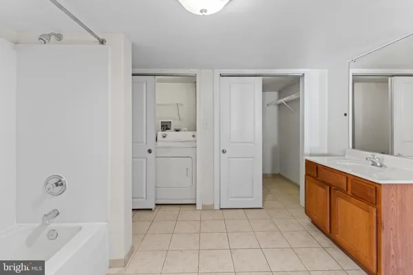 a bathroom with a tub sink and mirror