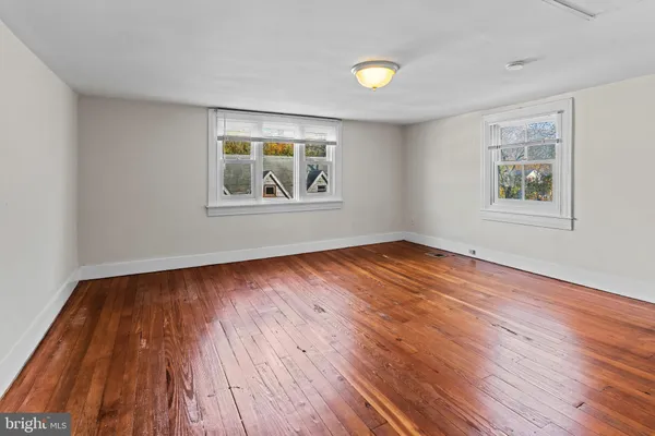 a view of an empty room and wooden floor