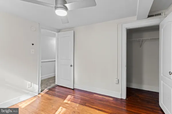 a view of an empty room and wooden floor