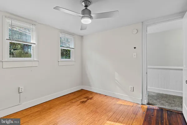 a view of empty room with wooden floor