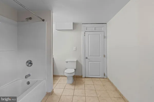 a bathroom with a toilet and a bathtub