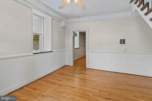 wooden floor in an empty room with a window