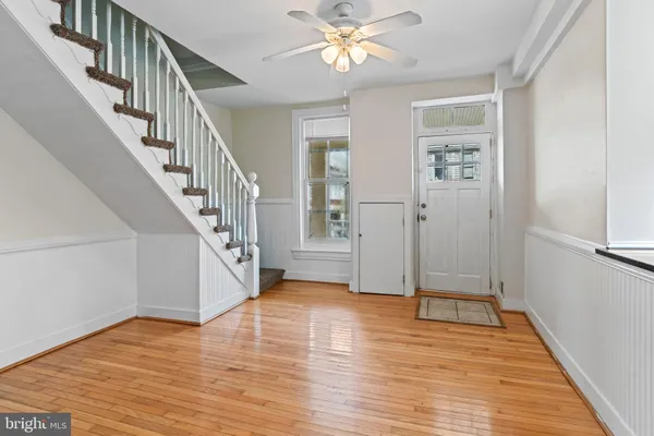a view of an entryway with wooden floor