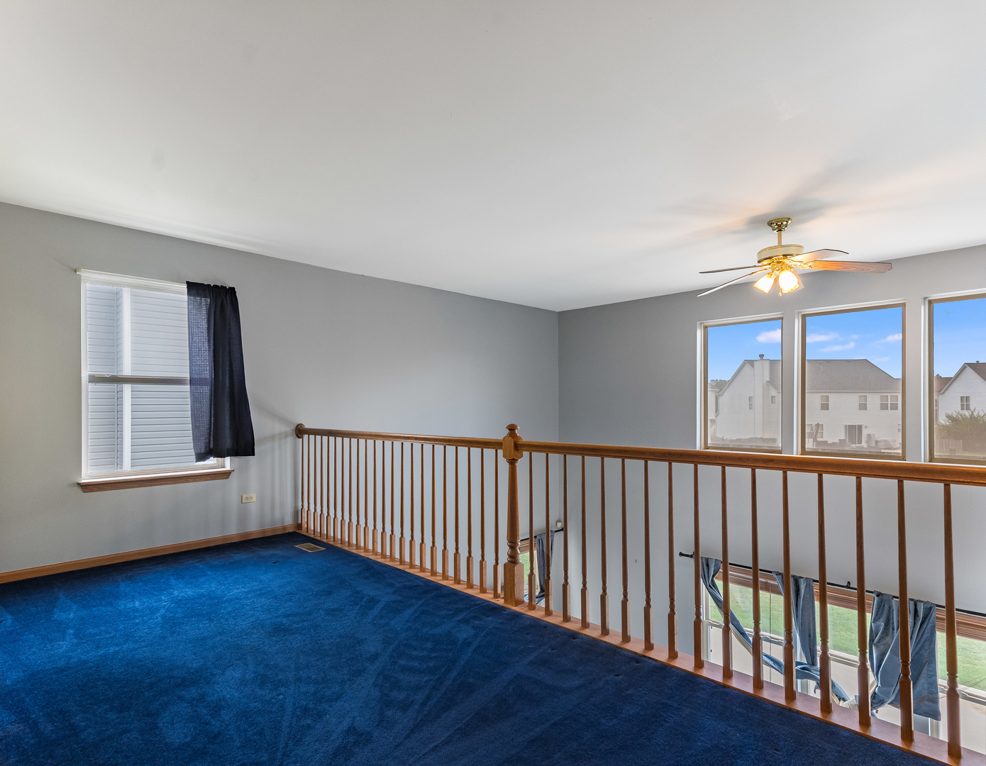 1910 Arbor Fields Drive Plainfield, IL 60586 - Photo 15 of 26 a view of an empty room with wooden floor and fan