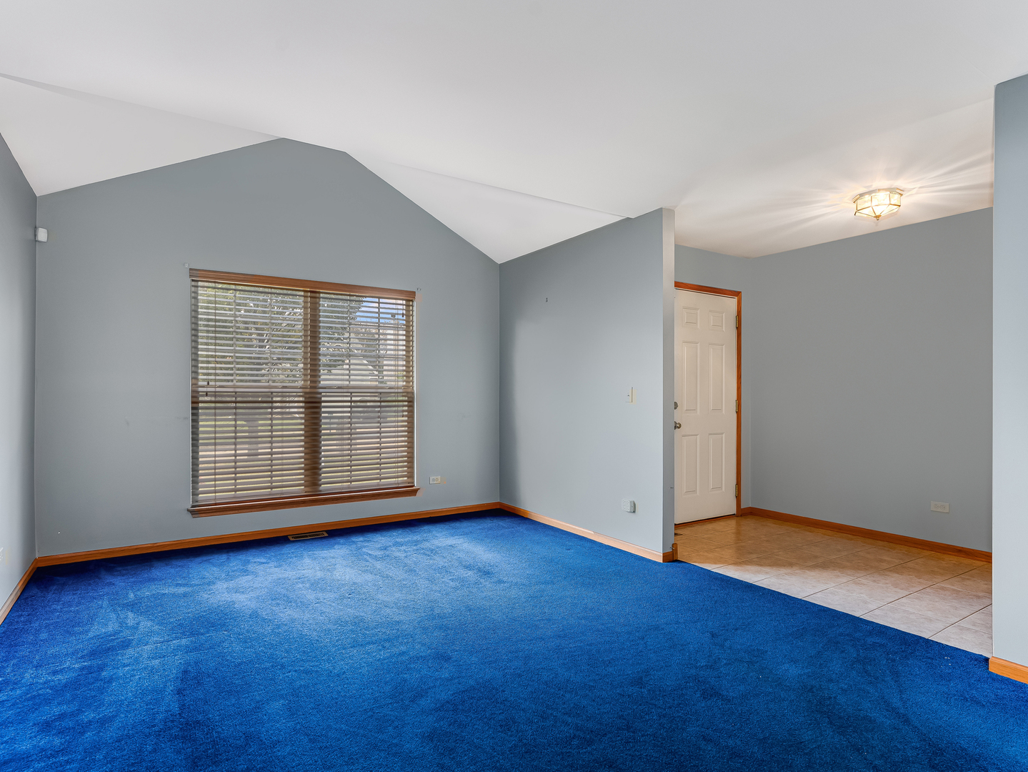 1910 Arbor Fields Drive Plainfield, IL 60586 - Photo 3 of 26 a view of an empty room with wooden floor and a window