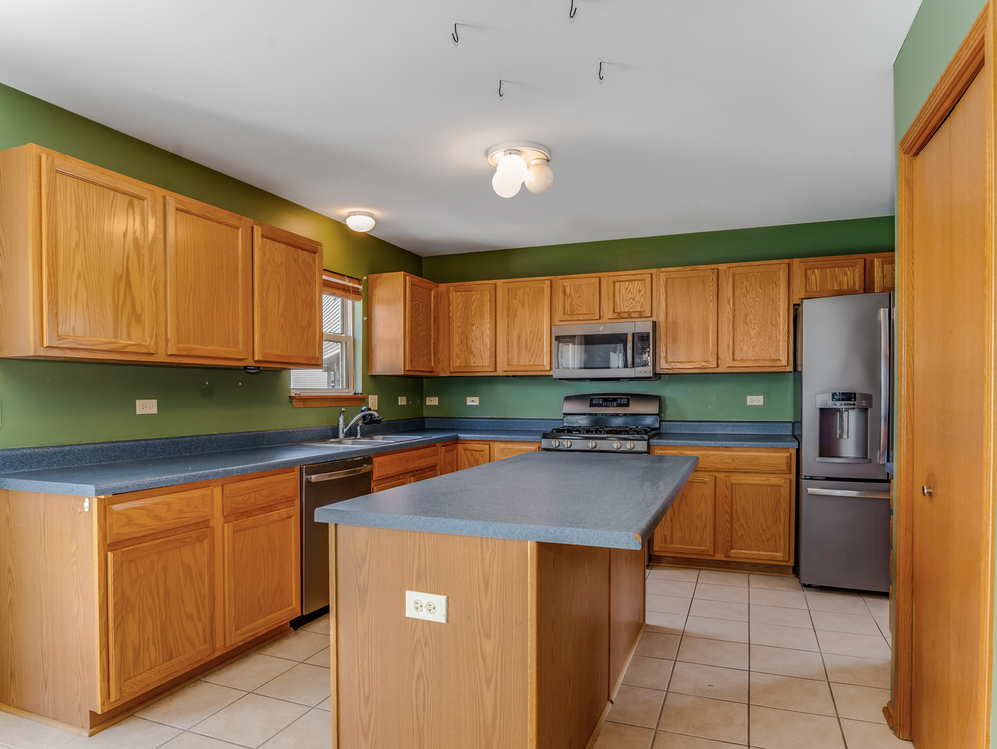 1910 Arbor Fields Drive Plainfield, IL 60586 - Photo 7 of 26 a kitchen with stainless steel appliances granite countertop a refrigerator sink and cabinets