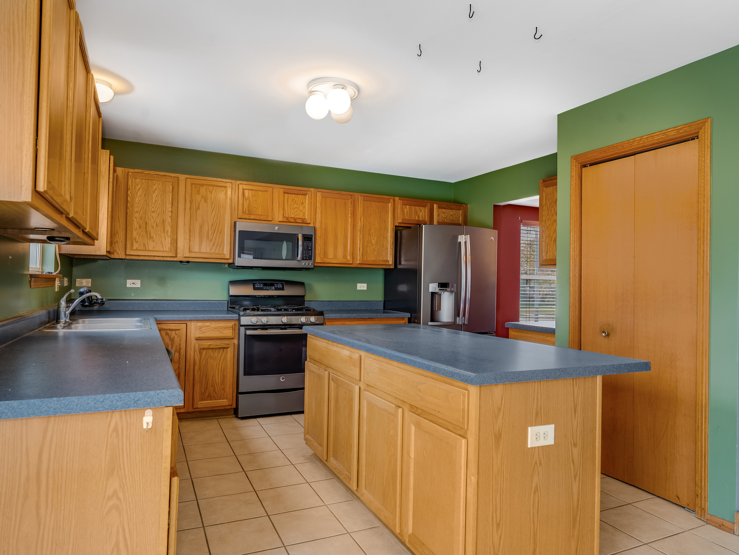 1910 Arbor Fields Drive Plainfield, IL 60586 - Photo 8 of 26 a kitchen with stainless steel appliances granite countertop a sink refrigerator and microwave