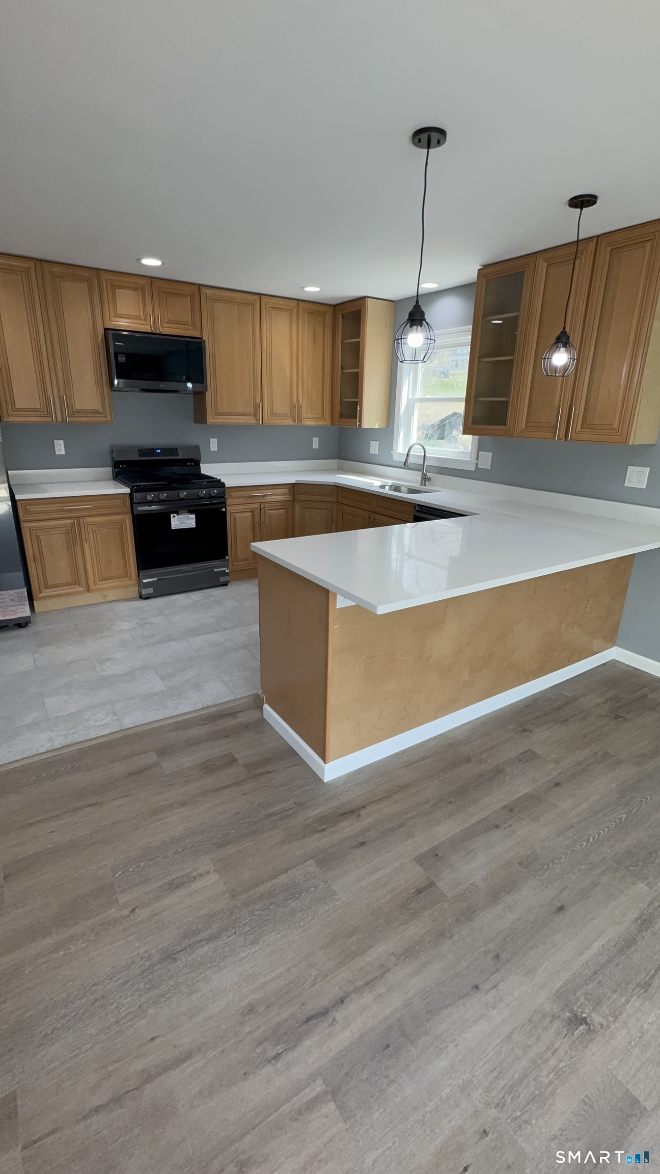 74 Prospect Hill Road New Milford, CT 06776 - Photo 8 of 16 a kitchen with granite countertop a stove and a wooden floor