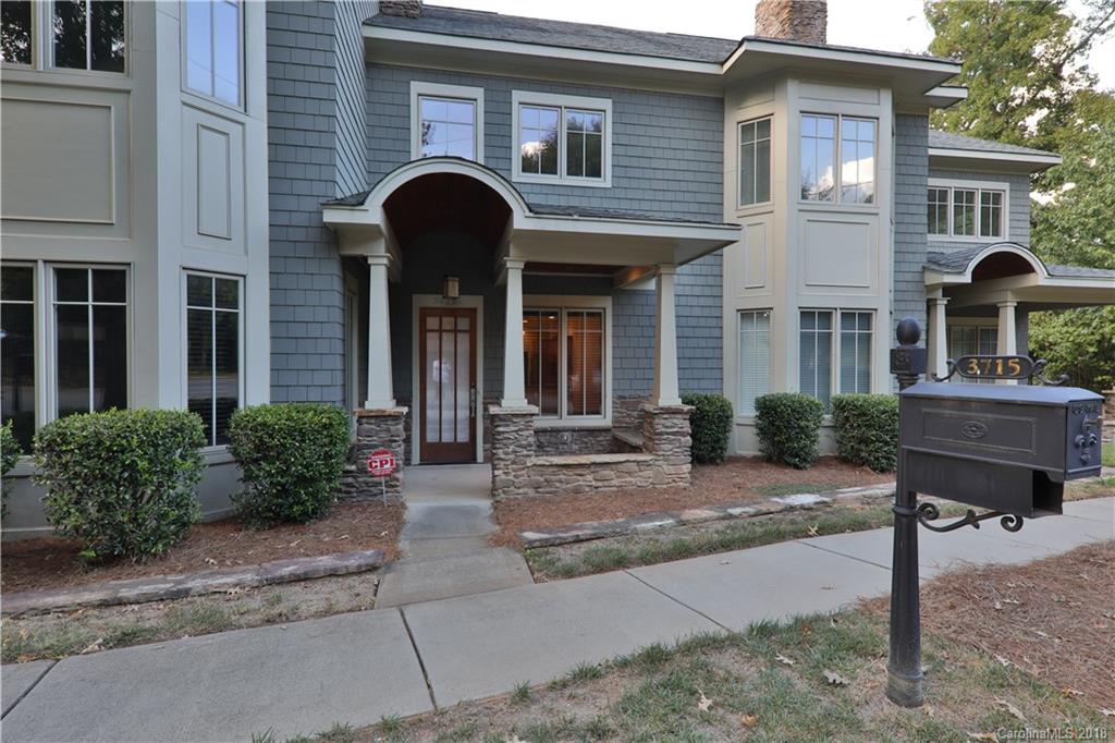 a front view of a house with yard and glass windows