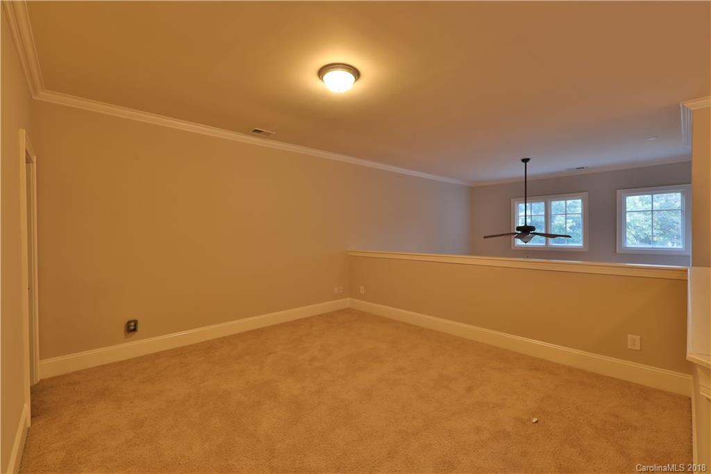 3715 Churchill Road Charlotte, NC 28211 - Photo 16 of 19 an empty room with ceiling fan and windows