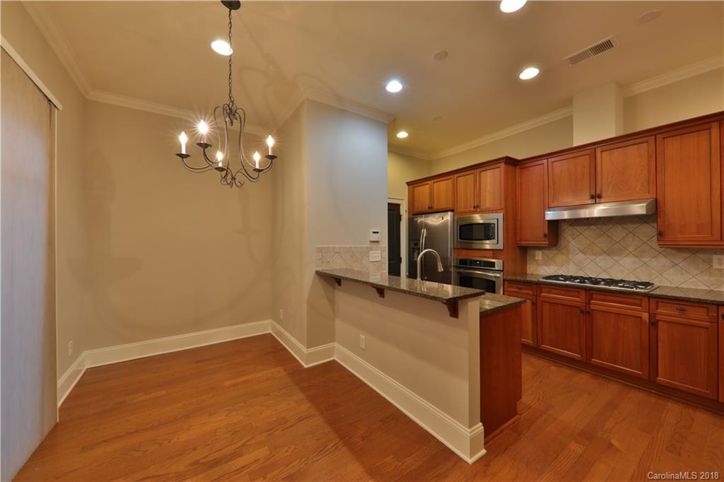 3715 Churchill Road Charlotte, NC 28211 - Photo 5 of 19 a kitchen with stainless steel appliances granite countertop a sink stove and refrigerator