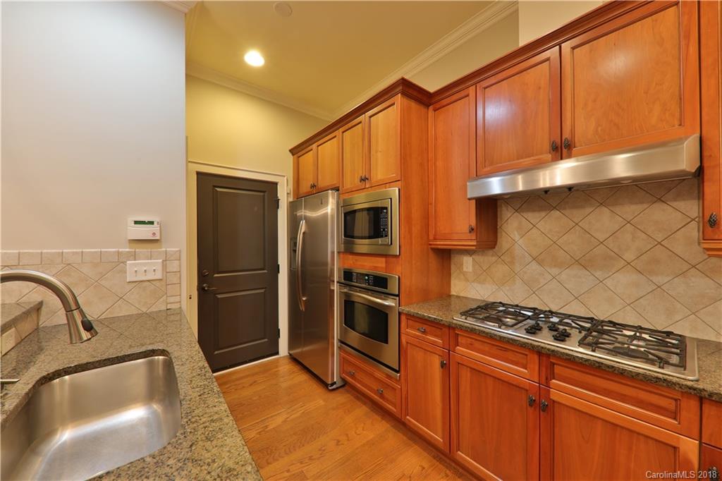 3715 Churchill Road Charlotte, NC 28211 - Photo 6 of 19 a kitchen with stainless steel appliances granite countertop a refrigerator and a sink