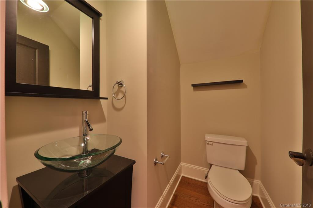 3715 Churchill Road Charlotte, NC 28211 - Photo 7 of 19 a bathroom with a toilet a sink and mirror