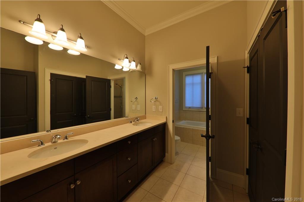 3715 Churchill Road Charlotte, NC 28211 - Photo 9 of 19 a bathroom with a double vanity sink and a mirror