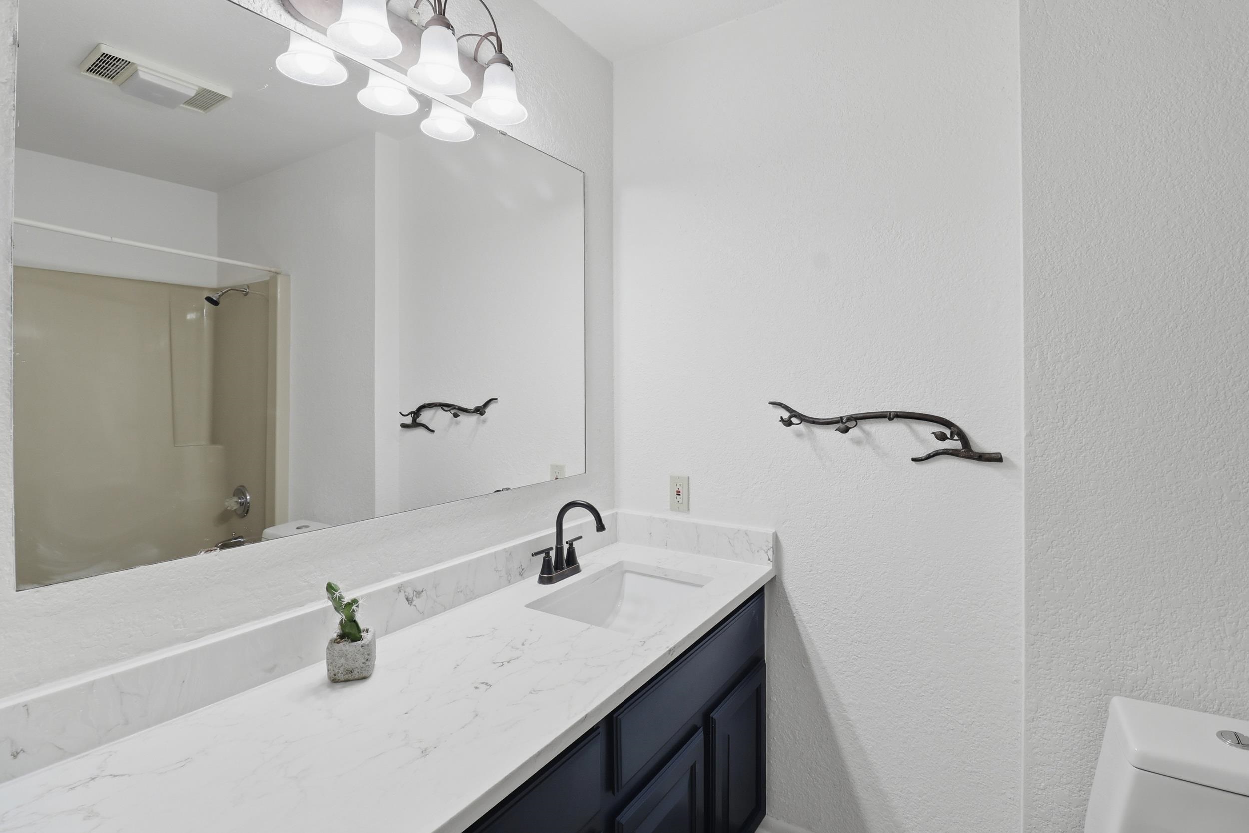 100 Bay Point Drive, Unit 3 Horseshoe Bay, TX 78657 - Photo 17 of 26 a bathroom with a sink a light fixture and a vanity