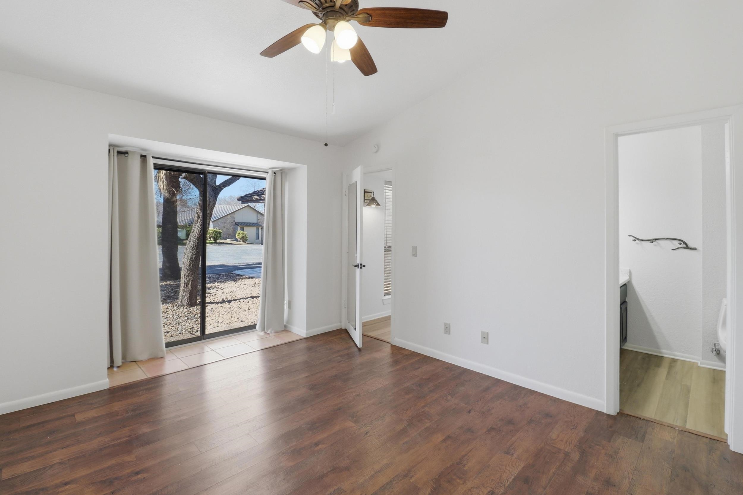 100 Bay Point Drive, Unit 3 Horseshoe Bay, TX 78657 - Photo 18 of 26 an empty room with wooden floor cabinet and windows