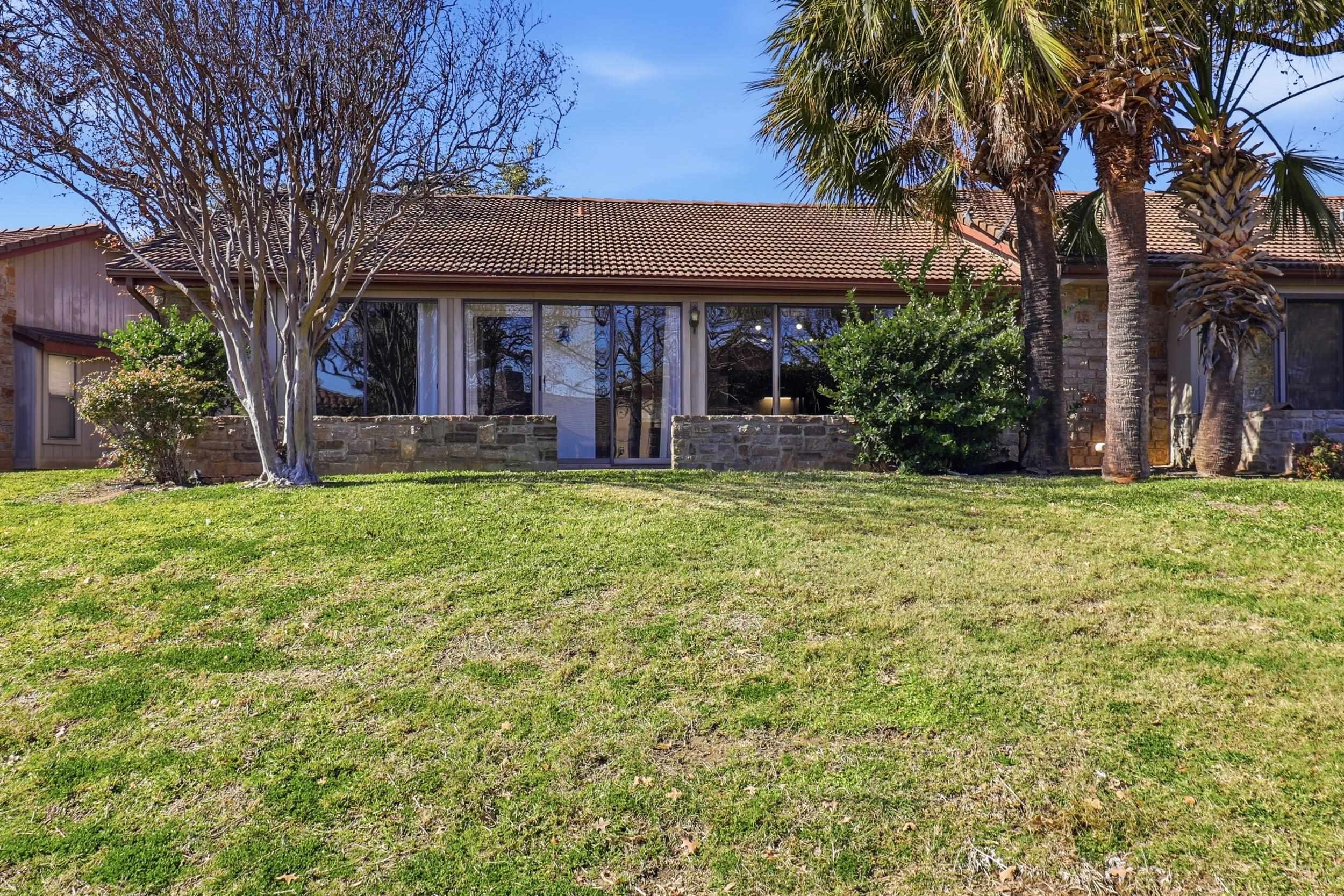 100 Bay Point Drive, Unit 3 Horseshoe Bay, TX 78657 - Photo 22 of 26 a view of a house with a yard and sitting area