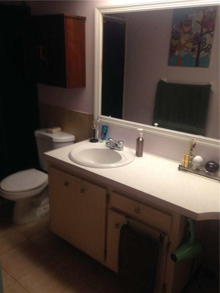 1150 East Sample Road, Unit 107 Pompano Beach, FL 33064 - Photo 7 of 12 a bathroom with a sink and a toilet